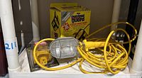 Yellow Jacket branded 8-outlet power center with dual overload guard in original box, yellow cords visible, scratches noted. Photo taken to show power center and packaging.