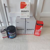 All items arranged showing Oxy products, Hero Mighty Patch boxes, and Neutrogena exfoliating treatment on table