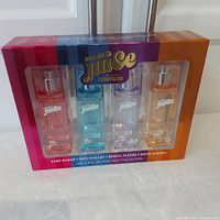 Full box of Eau De Juice body mists by Cosmopolitan showing all four bottles in sealed packaging.