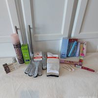 Full lot spread with products and winter accessories on white surface below cabinet doors