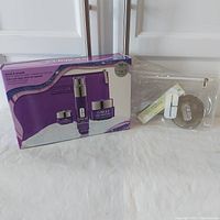 Photo of full lot showing Clinique Smart & Smooth skincare set in box, clear carry bag, folding mirror, and lipstick.