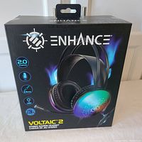 Front view of sealed Enhance Voltaic 2 gaming headset box showing headset image and branding.