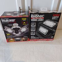 Photo of both Bell + Howell light boxes showing the TriBurst Active Deluxe and Bionic work light models.