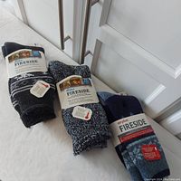 Three pairs of Airplus Fireside socks arranged together showing packaging and labels.