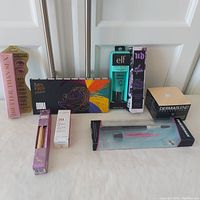 Full lot of makeup products on white surface showing all items included in the lot.