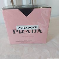 Front view of pink Prada Paradoxe perfume box, shows product and brand name.