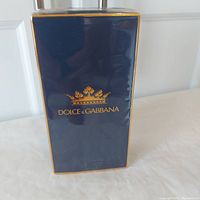 Front view of the sealed Dolce & Gabbana K EDT box showing navy blue color with gold trim and brand logo.