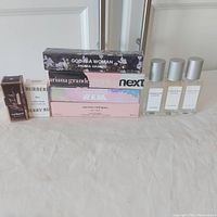 Full lot with all perfume boxes and Allsaints bottles in view, arranged in a row