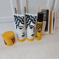 Full set of six Pattern hair care products on white background including gel jar, two conditioner tubes, mousse canister, and two boxed comb tools.