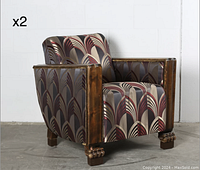 Front three-quarter view of one chair showing wood frame, geometric silk upholstery, and carved paw feet.