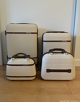 Front view of four-piece Lulusail luggage set including two upright spinners and two train-case carry cases