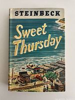 Front cover of Sweet Thursday showing coastal illustration and author name Steinbeck