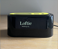 Front view showing Loftie logo and 'Waking up...' message on display