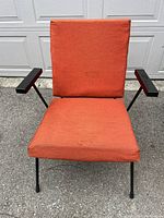 Front view showing full chair, orange-red upholstery with visible stains