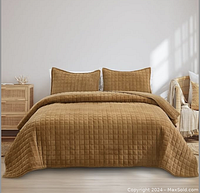 Front view of the bedspread set displayed on a queen size bed, showing gold caramel velvet fabric with a quilted pattern and two matching pillow shams.