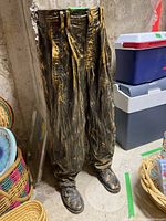 Front view of cast iron pants flower pot showing detailed legs and shoes