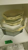 Stack of clear octagonal glass dinner bowls and plates, showing their shape and size.
