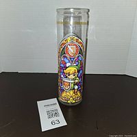 Front view of the Legend of Zelda glass candle holder showing Link in a stained glass style on clear glass with gold trim near the top