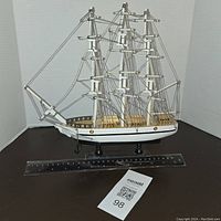 Front angle view of the wooden tall ship model with ruler for size reference