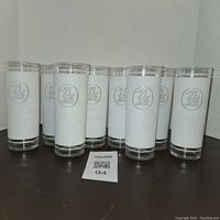 Set of 8 frosted highball glasses with Gilbey's Gin logo arranged side by side.