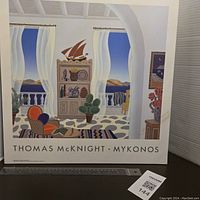 Front view of the vintage Thomas McKnight Mykonos wall plaque, showing the colorful Mediterranean interior scene framed by an archway with scenic balcony view.