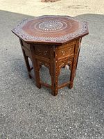 View of the octagonal table from an angle showing top and base details with inlay work.