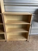 Front view of light wood 3-shelf IKEA bookcase showing overall condition and shelves