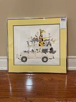 Framed print of safari vehicle and animals, showing overall condition and frame