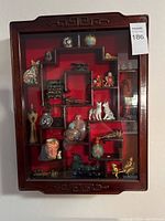 Full closed view of cabinet showing front glass door, stepped shelves and contents