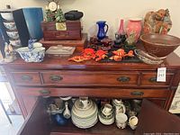 Top of cabinet showing assorted decorative items including vases, jewelry box, crustacean ornaments