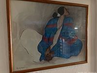 Framed lithograph of woman with blue blanket, capturing full artwork and frame.