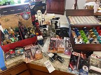 Overview of all items arranged on countertop including Star Wars figures, trays with discs, wooden display case