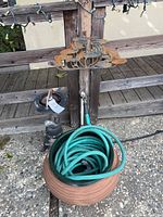 Photo showing full set with hose inside storage pot, ash tray stand and wood deck background