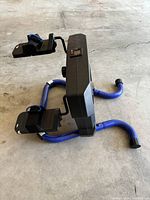 Scoop exercise machine showing blue frame, foot plates with straps and central control unit