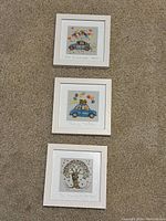 Top down image showing the three framed 6x6 Irish pictures with love quotes on carpeted floor.