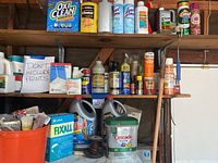 Overall view of shelves with a selection of cleaning and home improvement products including OxiClean, Lysol sprays, Cascade dishwasher detergent, WD-40, and plaster of Paris.