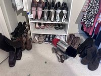 Overall assortment of shoes on rack and floor with Dremel polisher