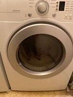 Front view of LG front-loading dryer showing control panel and door.