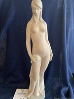 Front view of full figurine on dark backdrop