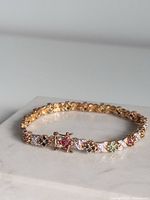 Bracelet on marble showing alternating colored stones and clasp