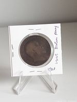 Obverse of 1910 British penny in holder showing King Edward VII bust