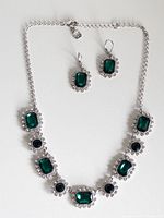 front view of necklace and earrings laid flat