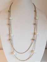 Full view of necklace on mannequin showing two strands with faux pearls and gold-tone beads