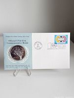 Front of first-day-cover showing medal mounted and stamp