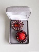 Buttons in grey presentation box showing cabochon centers and rhinestone settings