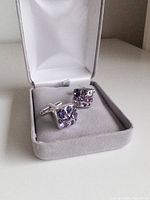Cufflinks in open grey box showing crystal faces