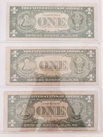 Backs of all three $1 silver certificates in sleeves