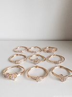 All nine gold-tone rhinestone bangles arranged on surface
