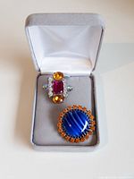 Open jewelry box showing both Czech glass buttons inside