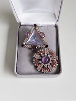 Both buttons displayed in jewellery box